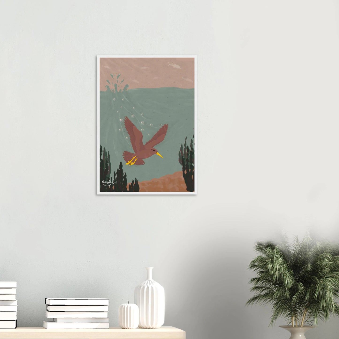 Diving Bird framed artwork displayed on a wall featuring a dusky pink bird diving underwater with splashes and bubbles