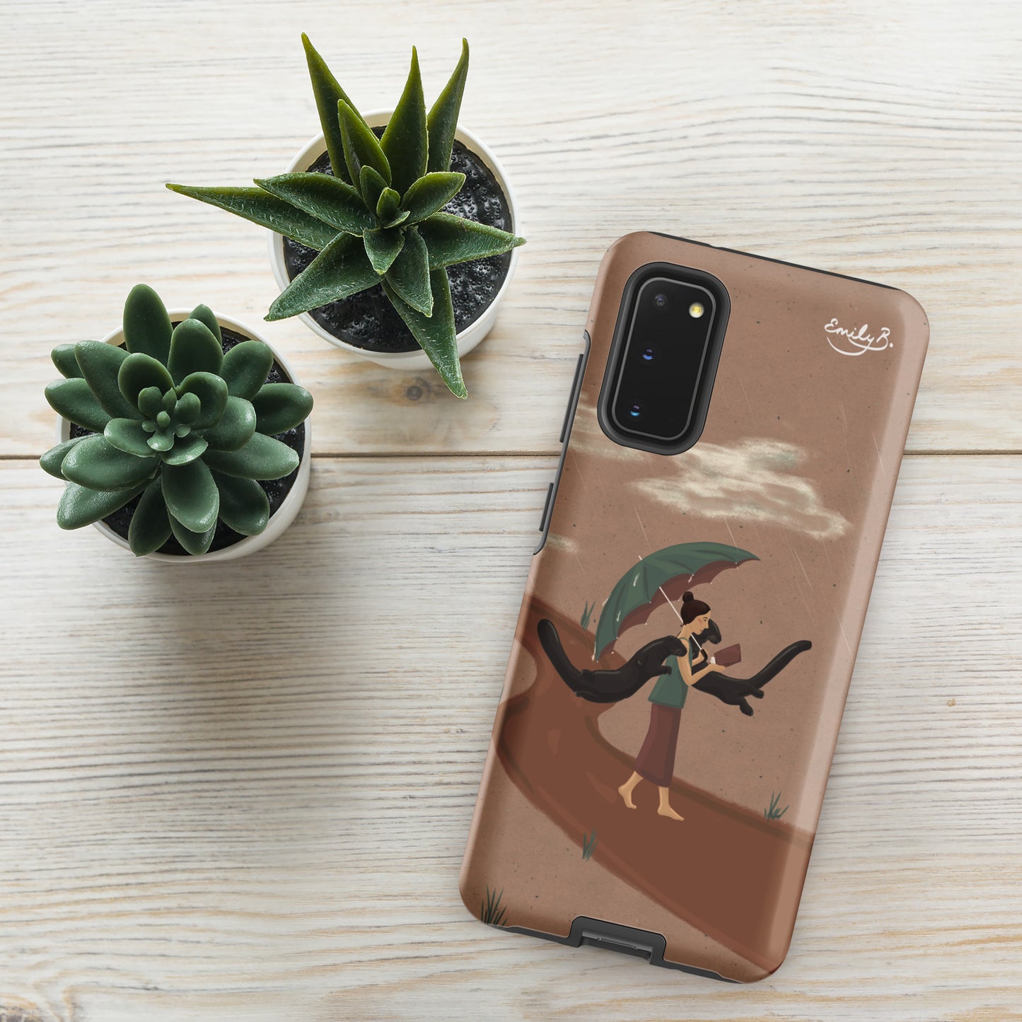 Phone case with artistic design on a wooden surface with plants